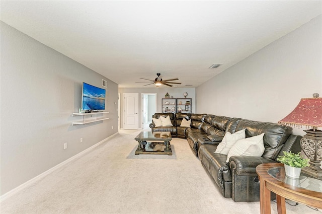 carpeted living room with ceiling fan