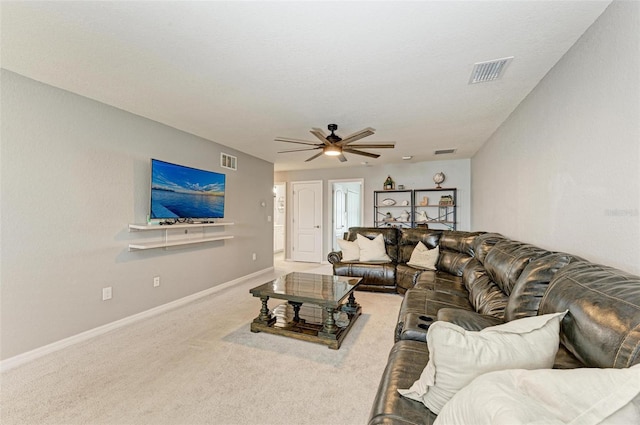 living room with ceiling fan and carpet