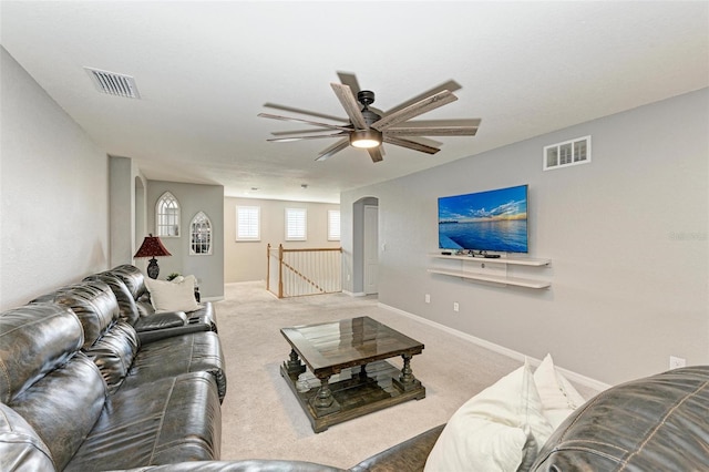 carpeted living room featuring ceiling fan