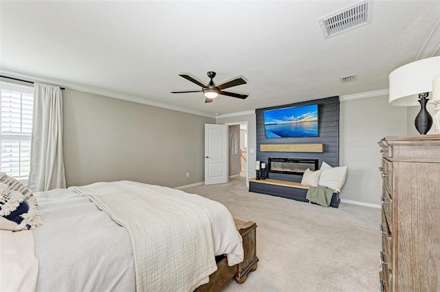 bedroom with a fireplace, light carpet, ornamental molding, and ceiling fan