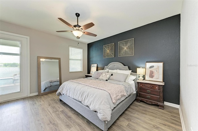 bedroom with ceiling fan and light hardwood / wood-style flooring