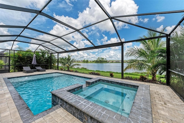 view of pool with a lanai, an in ground hot tub, a patio area, and a water view