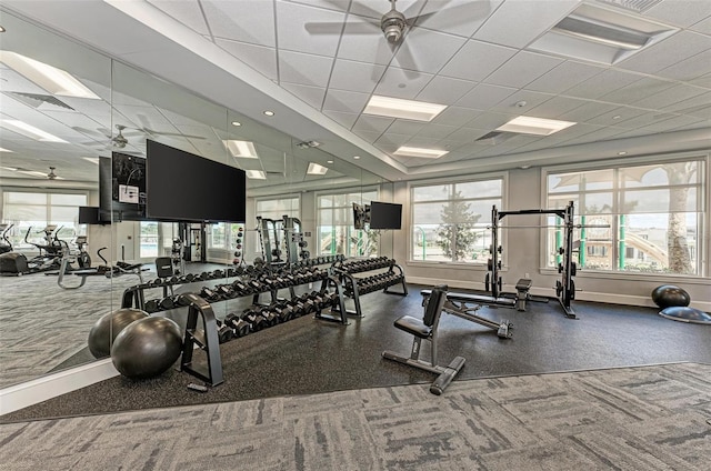 gym with ceiling fan and a drop ceiling