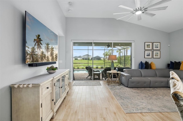 living room with vaulted ceiling, light hardwood / wood-style flooring, and ceiling fan