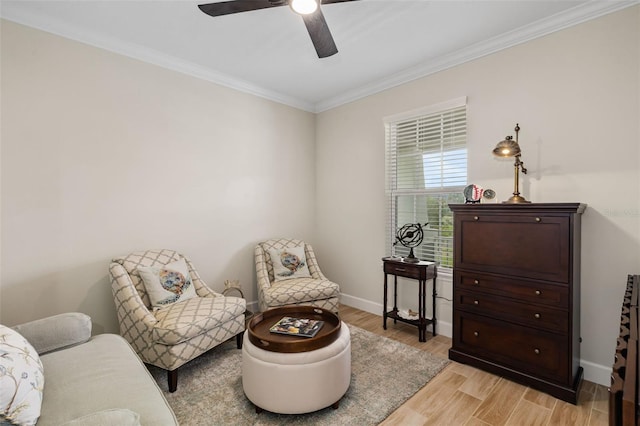 living area with light hardwood / wood-style flooring, ceiling fan, and ornamental molding