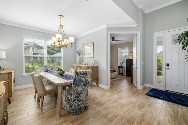 dining area featuring light wood-type flooring, ceiling fan with notable chandelier, plenty of natural light, and ornamental molding