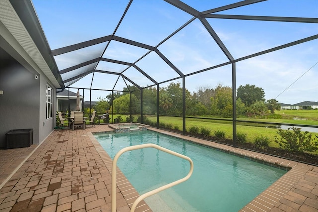 view of pool with a lanai, a patio, and an in ground hot tub