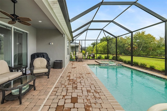 view of swimming pool featuring a lanai, an in ground hot tub, ceiling fan, and a patio