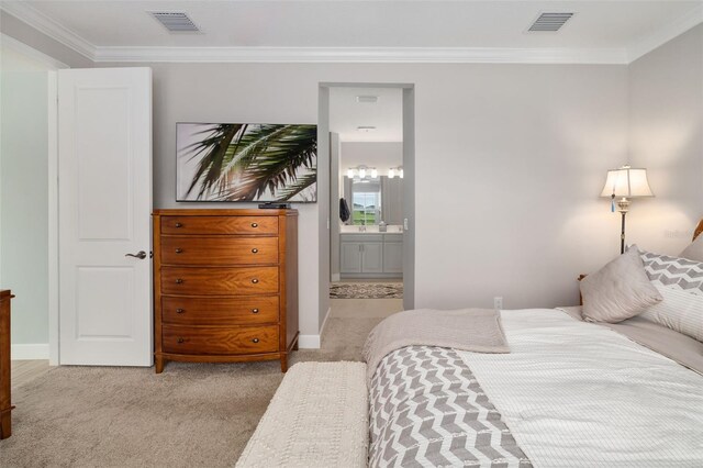 carpeted bedroom with connected bathroom and ornamental molding