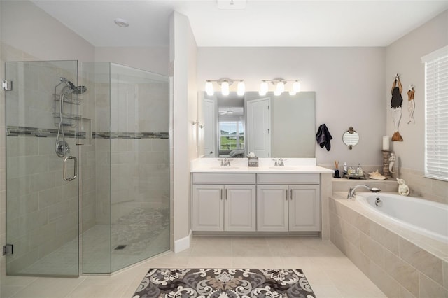 bathroom with tile patterned flooring, vanity, and plus walk in shower