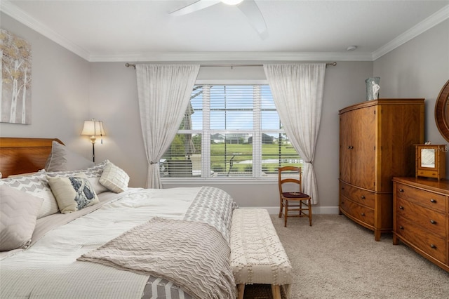 carpeted bedroom featuring ceiling fan and ornamental molding