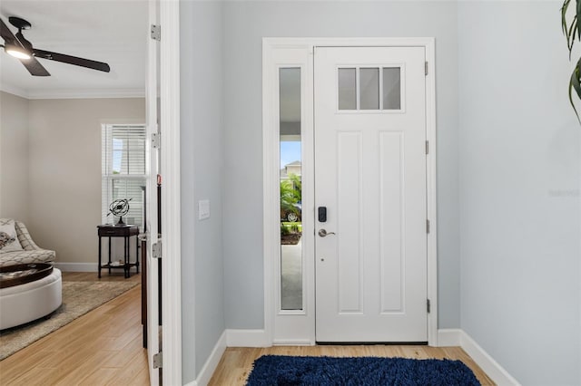 interior space with ornamental molding, light hardwood / wood-style flooring, and ceiling fan