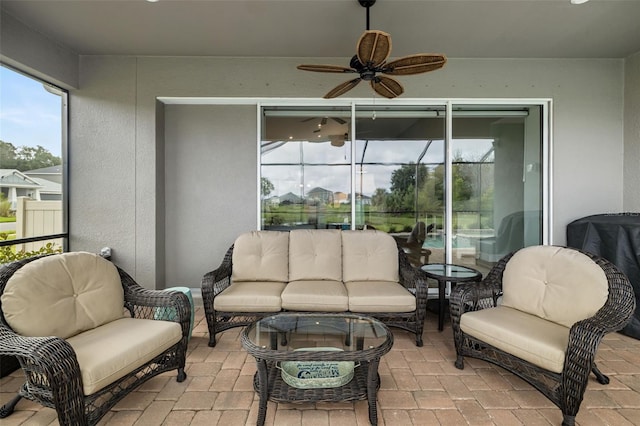 sunroom / solarium featuring ceiling fan