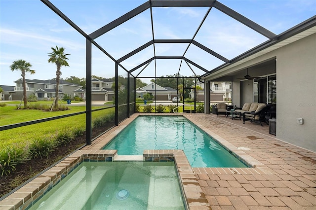 view of swimming pool with an in ground hot tub, a lanai, a patio, a yard, and an outdoor living space