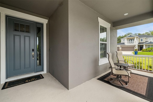 property entrance with a garage and a porch