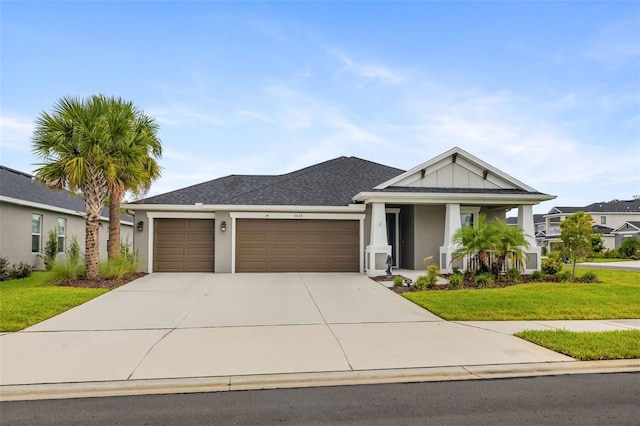 view of front of house featuring a garage and a front lawn