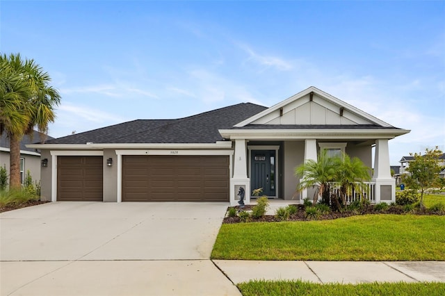 view of front of property with a front lawn and a garage