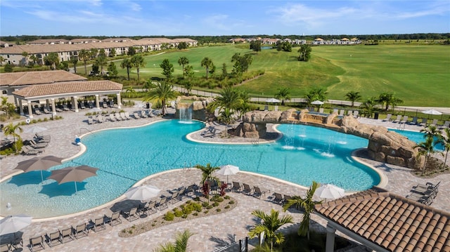 view of swimming pool featuring pool water feature and a patio area