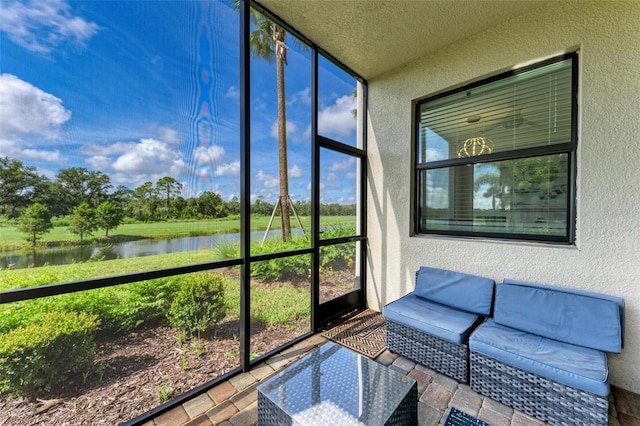 sunroom / solarium with a water view