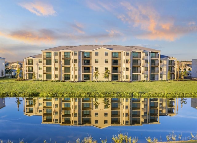 outdoor building at dusk featuring a water view