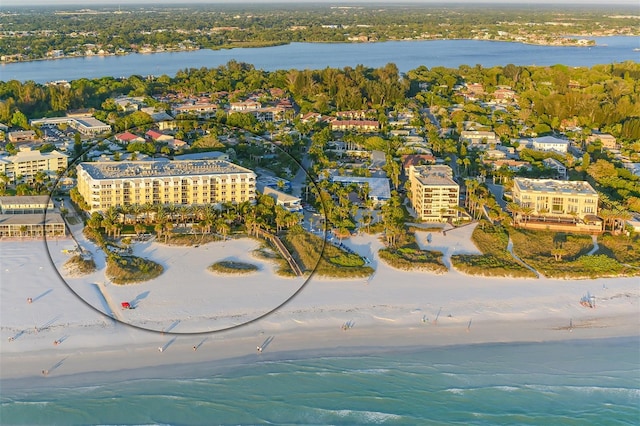 birds eye view of property featuring a beach view and a water view