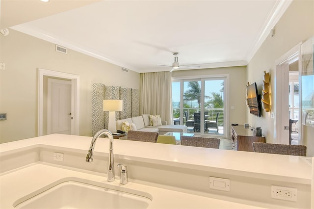 bathroom featuring crown molding, vanity, and ceiling fan