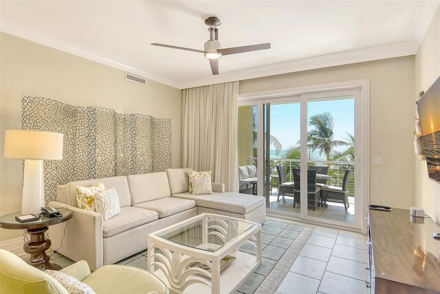 tiled living room featuring crown molding and ceiling fan