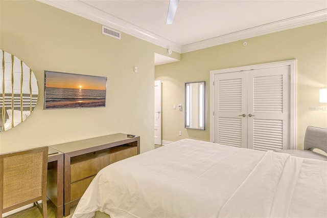 bedroom featuring ornamental molding, ceiling fan, and a closet