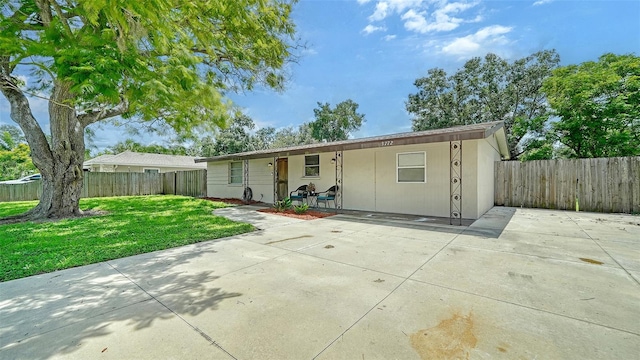 view of front of house featuring a front yard and a patio