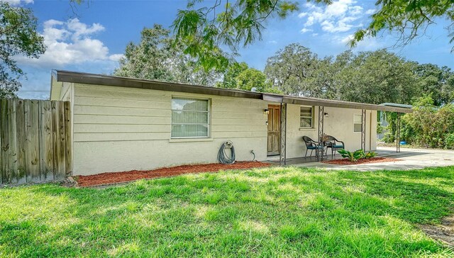 view of front of house featuring a front yard and a patio