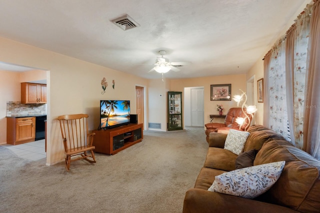 carpeted living room with ceiling fan