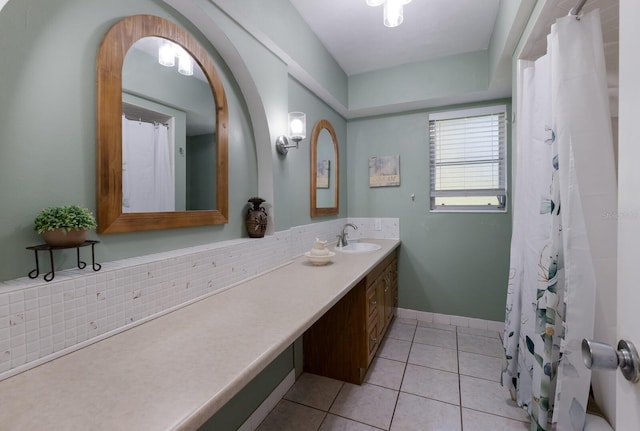 bathroom featuring tasteful backsplash, tile patterned flooring, and vanity