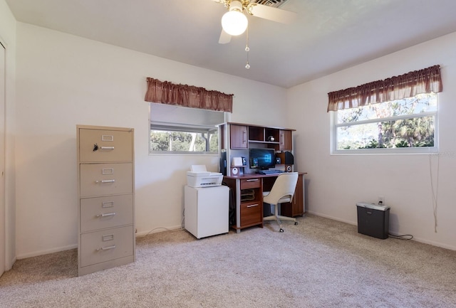 carpeted office space featuring a wealth of natural light and ceiling fan