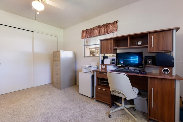 office space featuring ceiling fan and light carpet