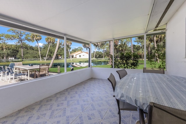 sunroom / solarium with a water view