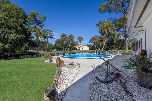 view of pool featuring a patio area and a lawn