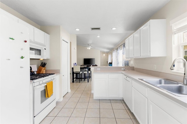 kitchen with vaulted ceiling, white appliances, sink, white cabinetry, and ceiling fan