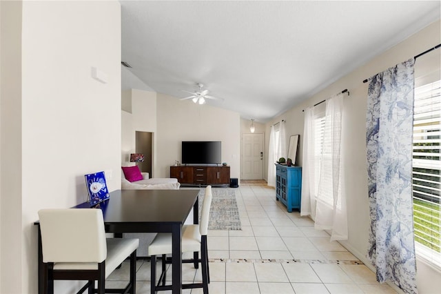 living room with lofted ceiling, ceiling fan, and light tile patterned flooring