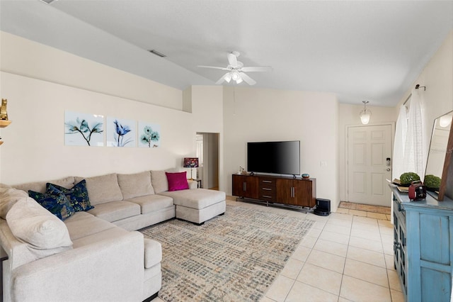 living room featuring lofted ceiling, ceiling fan, and light tile patterned floors