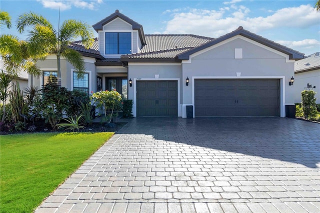 view of front facade featuring a front yard and a garage