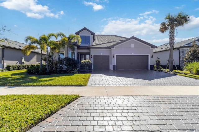 view of front of house featuring a front lawn and a garage