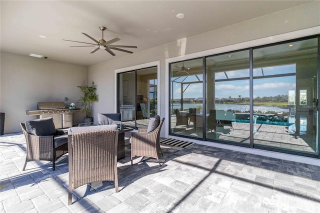 view of patio featuring a grill, ceiling fan, and a water view