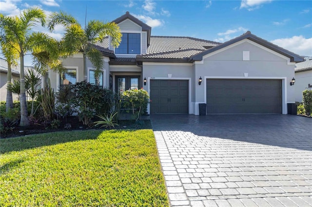 view of front of house with a garage and a front yard