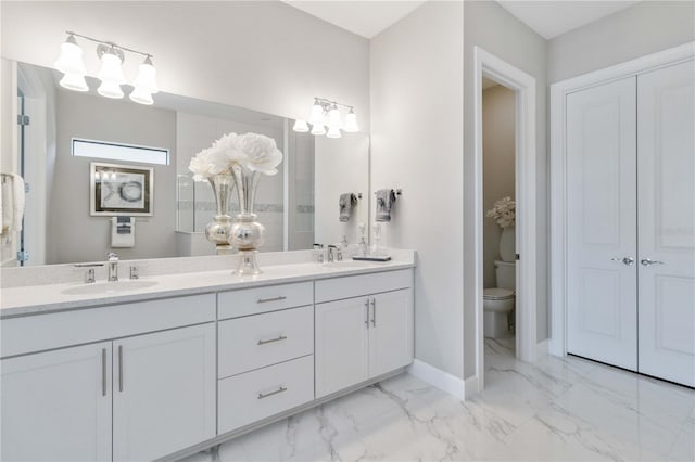 bathroom featuring vanity and toilet