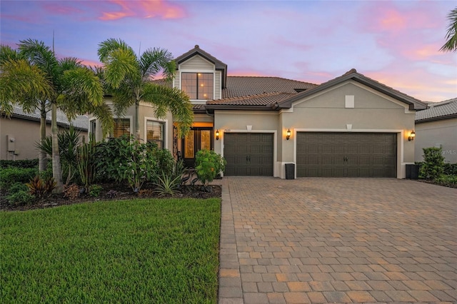 view of front of house with a lawn and a garage