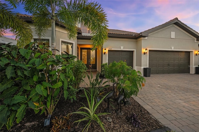 view of front of property with french doors and a garage