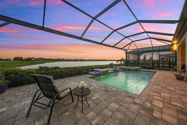 pool at dusk with an in ground hot tub, a patio, a water view, and a lanai