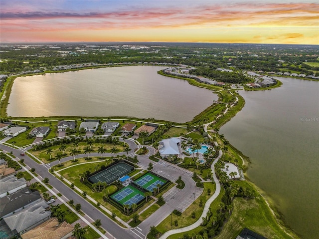 aerial view at dusk with a water view