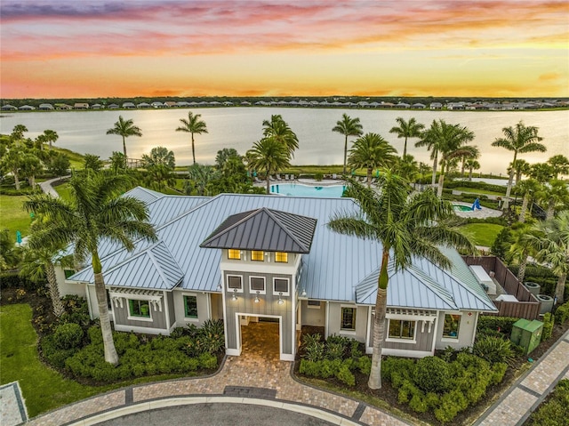 outdoor building at dusk with a water view and a garage