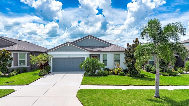 view of front of house featuring a front lawn and a garage